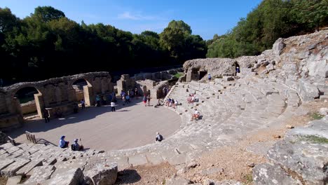 Tourists-Fill-the-Precious-Amphitheater-of-Butrint,-Exploring-the-Archaeological-Site-on-a-Vibrant-Summer-Vacation