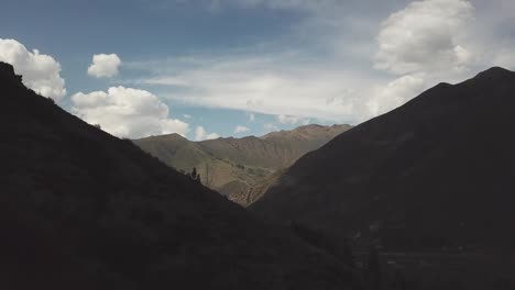 Flying-over-the-mountains-towards-the-horizon-near-Salto-del-Fraile,-Lima,-Peru