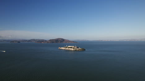 Aerial-view-approaching-the-Alcatraz-island,-golden-hour-in-San-Francisco,-USA
