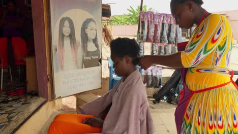 Kumasi-city-location,-hair-salon-with-staff-members-and-customer