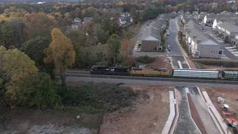 Cinematic-drone-shot-of-freight-train-carrying-steel-pipes,-Atlanta,-Georgia,-USA