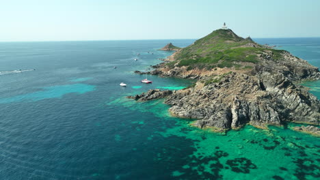 High-angle-drone-approaching-shot-to-Ile-de-Mezzu-Mare-in-Corsica-on-a-sunny-day