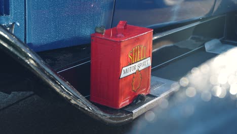 Red-vintage-Shell-Jerry-Can,-on-old-classic-car