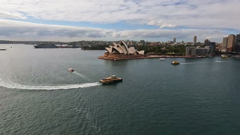 Tracking-Shot-Of-Sydney-Harbour-Ferry-Coming-Into-Circular-Quay-With-Large-Cruise-Ship-Docked