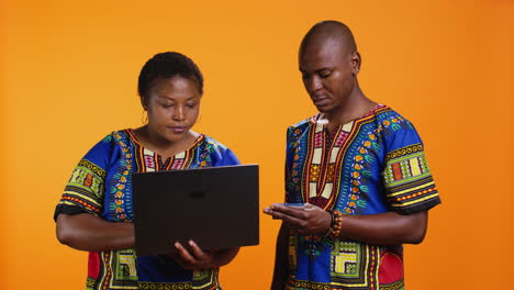 Ethnic-man-and-woman-doing-online-shopping-on-website