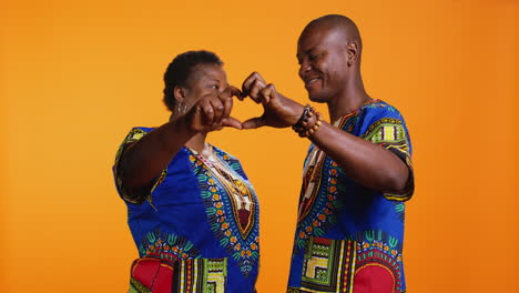 African-american-couple-doing-heart-shaped-sign