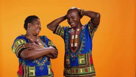 Cheerful-husband-and-wife-laughing-together-on-camera