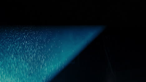 Abstract-dark-background-with-blue-cold-flashing-light-beam-spot-and-laser-illuminate-falling-rain-and-smoke