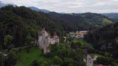 Aerial-view-of-ancient-Bran-castle,-gloomy-day-in-Carpathian-Mountains,-Romania