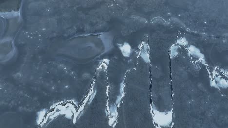 From-above,-a-large-body-of-water-freezes-in-winter,-and-the-ice-will-form-beautiful-patterns