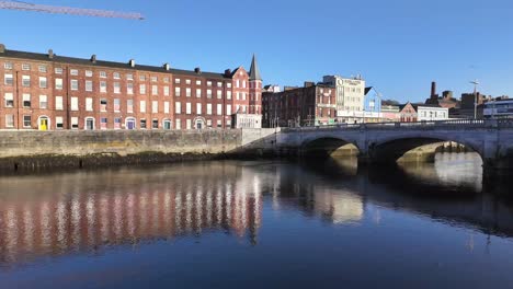 Calm-river-Lee-and-reflections-of-red-brick-row-of-houses-in-Cork-city-with-St
