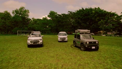 Drone-view-of-three-campervans-in-a-wide-field-near-the-Riviera-Maya,-Costa-Rica