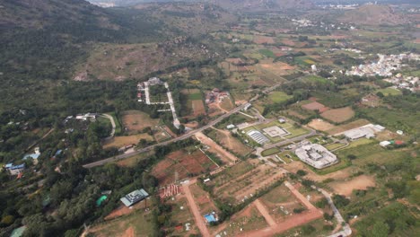 An-aerial-video-showing-the-outer-reaches-of-Bengaluru,-close-to-the-well-known-Nandhi-Hills,-beneath-a-yoga-center