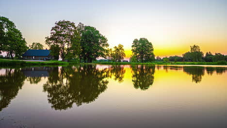 Timelapse-of-beautiful-dawn-to-vibrant-burst-of-sunrise-at-serene-lakeside