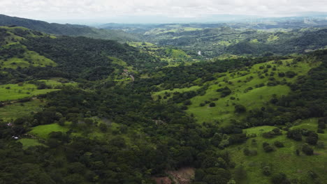 Costa-Rica-aerial-green-field-mountains-valley-view-drone-above-scenic-natural-unpolluted-nature-in-central-America