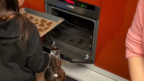 Putting-gingerbread-cookie-dough-in-the-oven---slow-motion