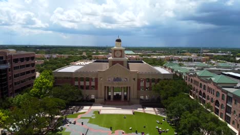 An-aerial-shot-of-Sugar-Land's-Towne-Hall-Building,-on-a-partly-cloudy-day,-at-60-frames