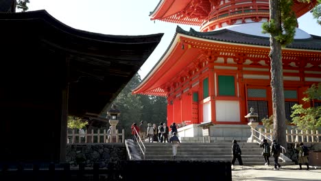 Visitors-Climbing-Stairs-Leading-To-Danjo-Garan,-Viewed-From-Kongobu-ji-Fudodo-At-Koyasan