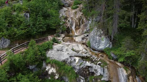 Small-waterfall-next-to-a-hiking-trail-in-the-Alps-in-Lofer,-Austria