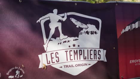 Slow-motion-shot-of-the-Festival-Des-Templiers-emblem-on-banners