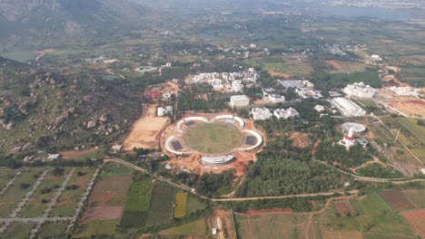 An-aerial-video-shows-how-agricultural-land-is-being-converted-to-urbanization,-which-causes-deforestation,-as-a-new-satellite-township-is-being-built-close-to-Bangalore's-outskirts