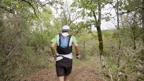 Following-shot-of-a-trail-runner-running-the-Festival-Des-Templiers-route