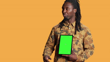 African-american-adult-with-greenscreen-on-gadget