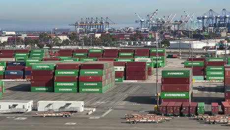 Busy-Harbor-with-Cargo-Ships,-Cranes,-and-Workers-Handling-Shipping-Containers