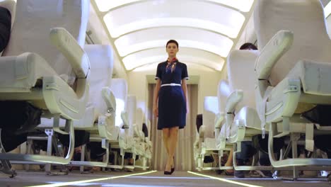Cabin-crew-walking-in-airplane-during-a-night-flight