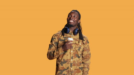 African-american-casual-person-drinking-coffee-cup-on-camera