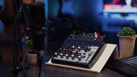 Close-up-shot-of-analog-mixer-and-microphone-used-to-produce-impeccable-sound-quality