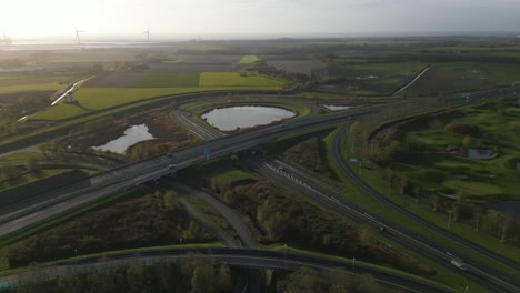 Aerial-tilt-down-over-highway-in-Middelburg-at-sunset,-Zeeland,-Netherlands