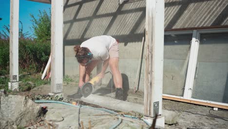 Man-Cutting-Concrete-Using-An-Angle-Grinder-In-The-Backyard