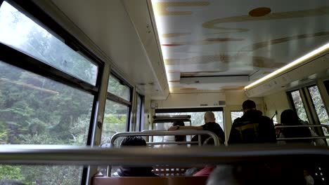Inside-Cable-Going-Up-Towards-Koyasan-With-Tourists-Looking-Out-Window
