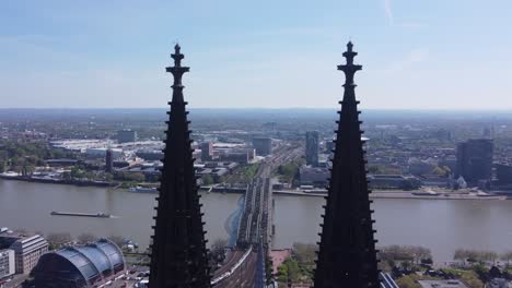 Hohenzollern-bridge-and-river-Rhine-view-through-spires-of-Cologne-cathedral