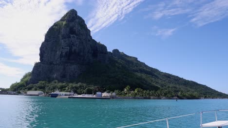 View-from-sailboat:-Steep-rocky-mountain-on-small-Polynesian-island