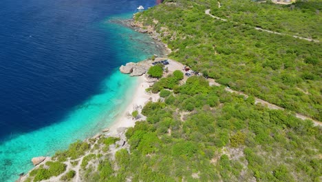 Panoramic-aerial-parallax-orbit-establishes-Director's-bay-Curacao-secluded-white-sand-beach-and-swimming-cove