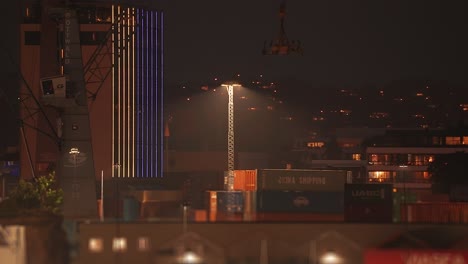 Kristiansand-port-at-night---rows-ff-shipping-containers-and-brightly-illuminated-office-buildings
