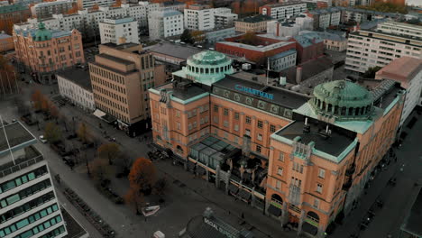 Pedestrian-street-and-buildings-of-Vaasa-city-in-Northern-Europe,-aerial-orbit-4k