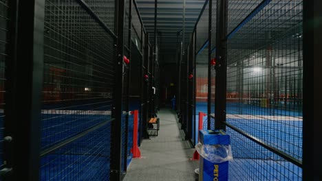 Empty-hall-of-padel-courts-that-has-lost-its-popularity---gimbal-wide-shot-moving-forward