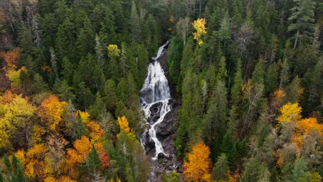 Waterfall-surrounded-by-fall-foliage-in-New-Hampshire-from-an-aerial-view