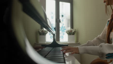 Pretty-Asian-girl-plays-piano-at-home-in-cosy-environment