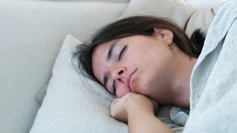 Young-Woman-Enjoying-a-Deep-Sleep-on-a-Cozy-Pillow