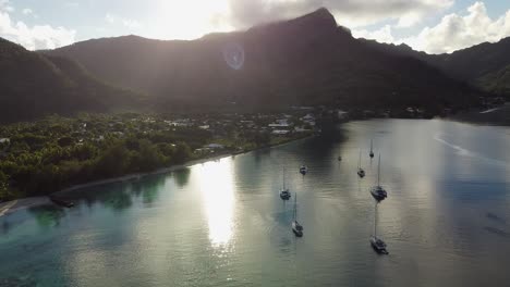 Lens-flare-aerial-retreats-from-tropical-Polynesian-island-village