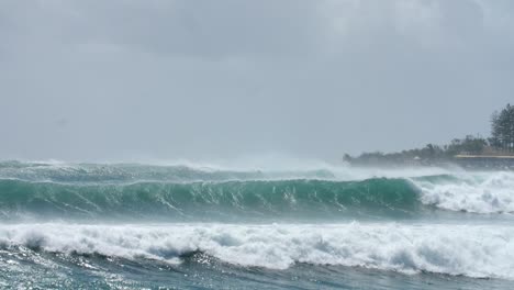 Powerful-Waves-and-Surfers-in-the-Ocean-During-Cyclone-Season-on-Coast-of-Australia,-Slow-Motion