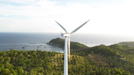 Windmill-on-a-Tropical-Island-by-the-Ocean-Coast-on-a-Beautiful-Clear-Day,-Aerial