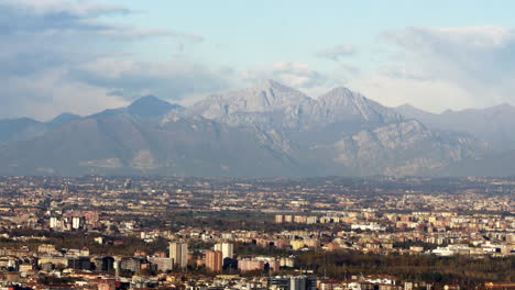 Majestic-Alps-and-Milan-city-bellow,-aerial-static-view