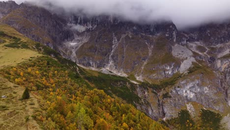 Beautiful-autumn-fall-mountain-landscape,-aerial-drone-view,-cloudy-peaks