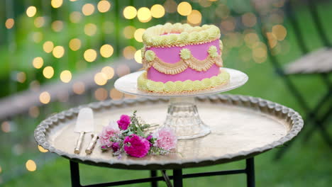 Pink-Heart-Cake-With-Yellow-Frosting-On-Silver-Serving-Tray-With-Roses,-4K-Slow-Motion