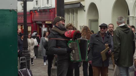 Man-Plays-Accordion-with-a-Cat-on-Top-of-It-in-Parisian-District-of-Montmartre